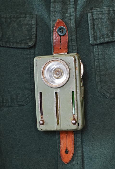 vintage flashlight on work shirt