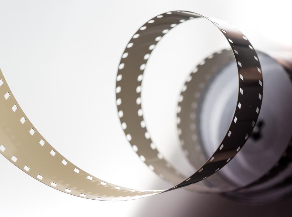 Close-up of the shiny swirl movie film, with the shadow, in light, clipart