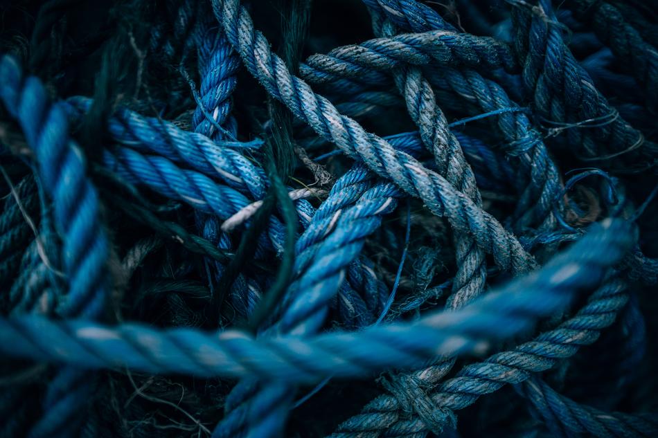 Close-up of the green and blue ropes, among the darkness