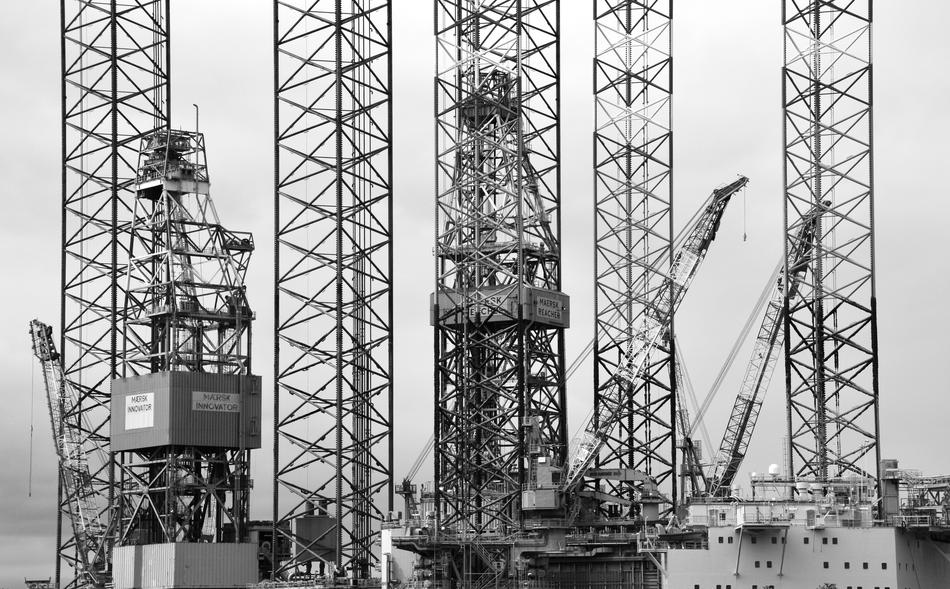 Black and white photo of the refinery machines, at foggy landscape