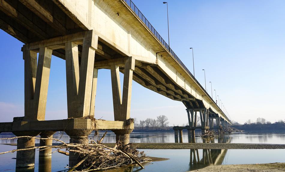 low angle view of concrete Bridge across po river, italy, pieve porto morone