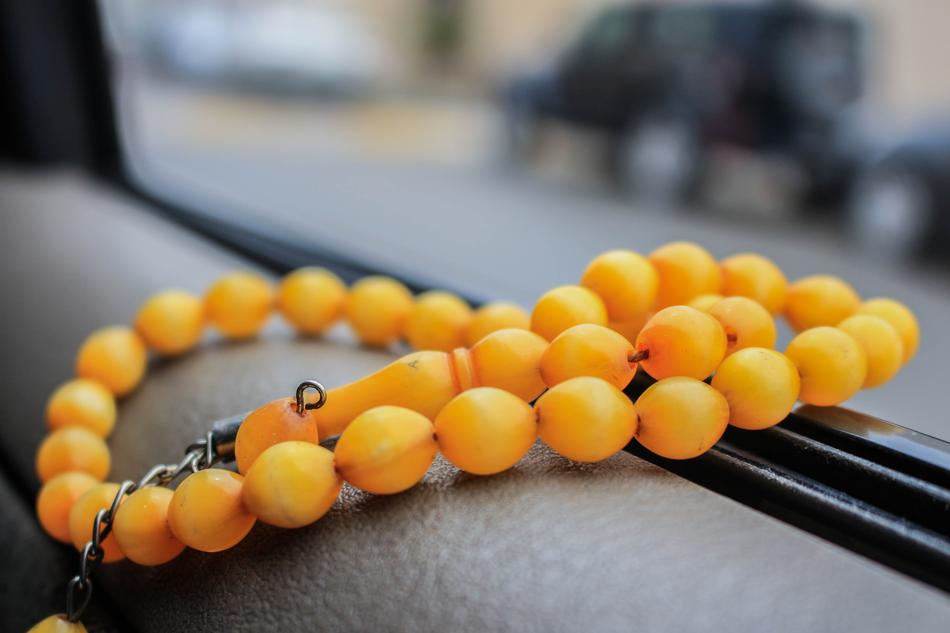 yellow rosary beads in islam on blurred background