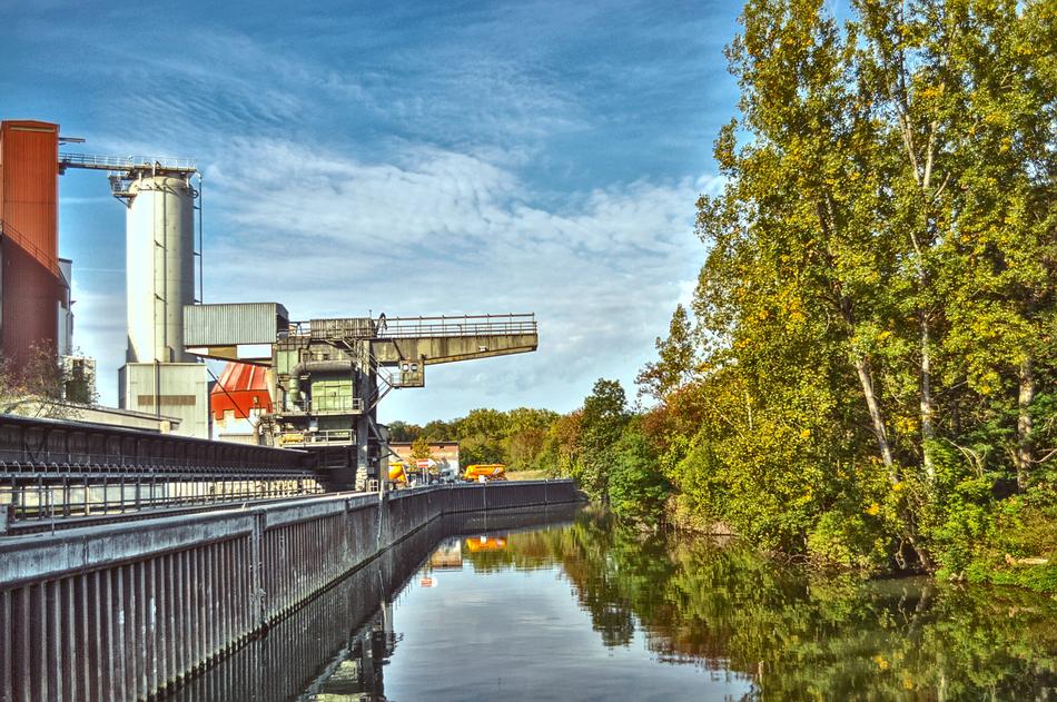 Industry near the river and beautiful and colorful trees
