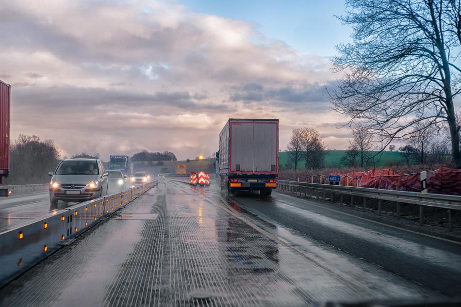 traffic on a wet highway at dusk