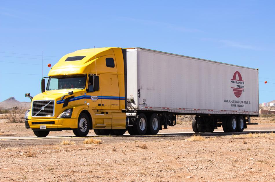 Colorful semi-truck on the road among dessert