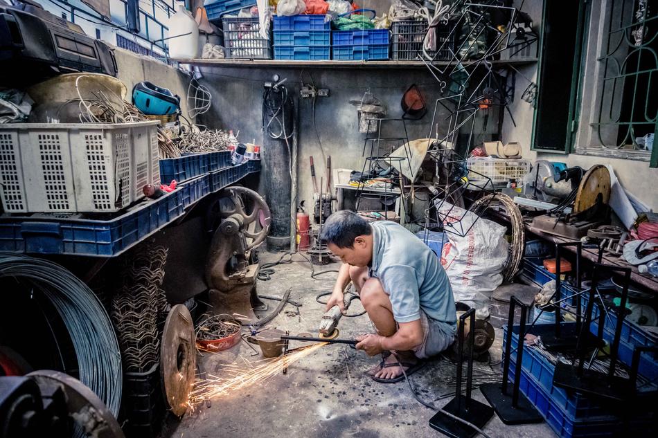 Worker, in the colorful factory, with the colorful stuff and tools, inside