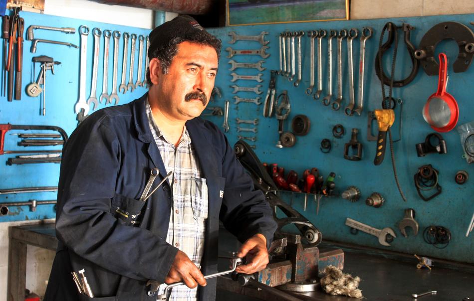 Master worker, with the moustache, working with the tools