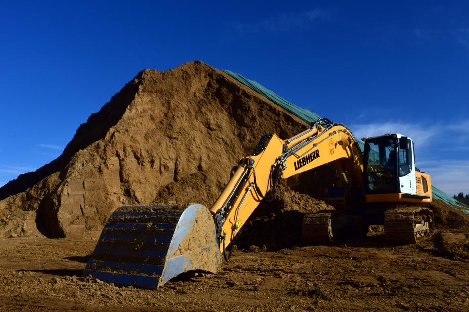 excavator extracts clay