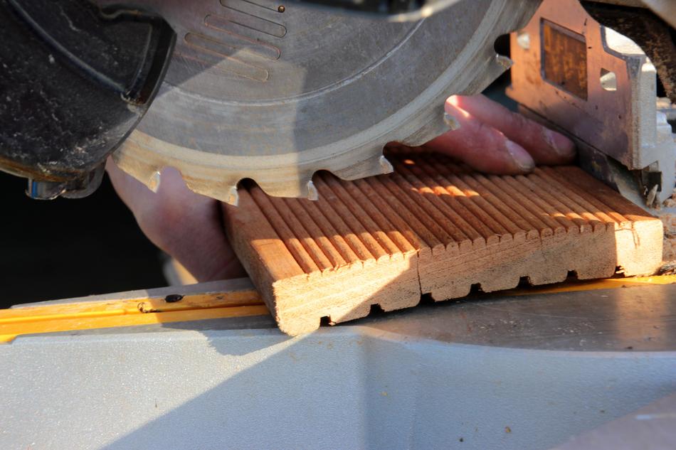 teeth of Crosscut Saw above wooden board