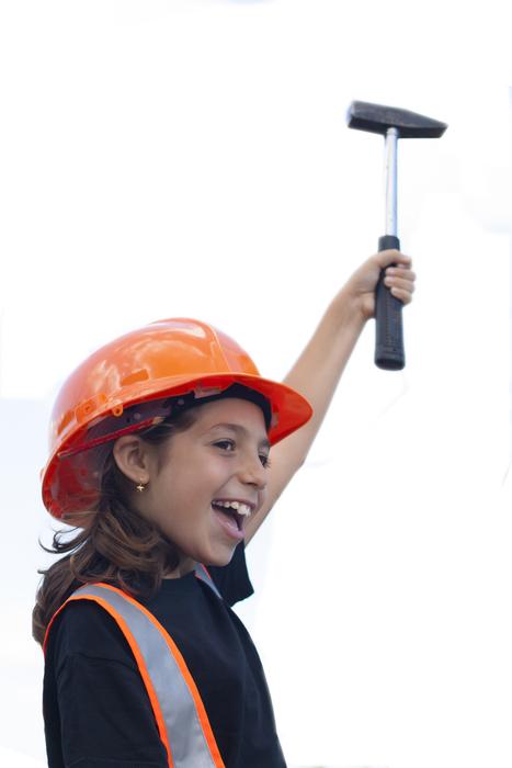 photo of a girl in an orange helmet with a hammer