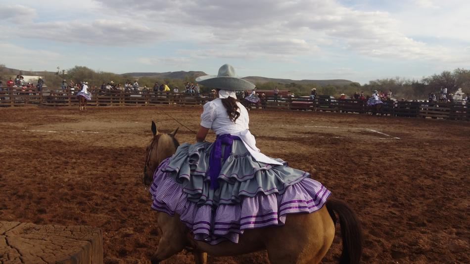 photo of mexican rider in beautiful purple dress