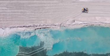 Aerial View of track bulldozer on sand beach