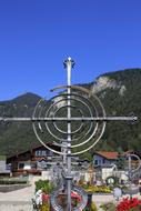 Wrought Iron Cross on grave near mountain, austria