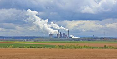 arable fields in the background of an industrial factory