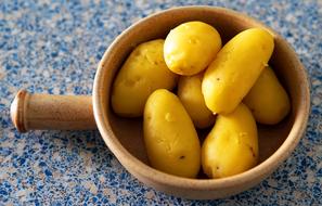 boiled potatoes in a wooden bowl
