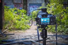 photo camera on tripod in front of Abandoned building