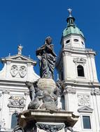 Beautiful Marian Column near the decorated cathedral at blue sky