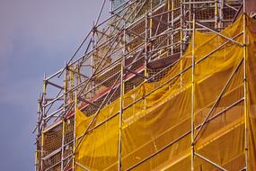 Scaffolding with yellow protective net at Building