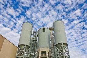 Industrial towers at cloudy sky