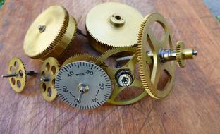 Bronze Gears with controller on the wooden surface