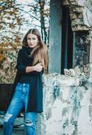 photo of a beautiful girl on the background of an abandoned building