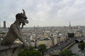 City panorama of Paris and Gargoyle statue on the roof in France