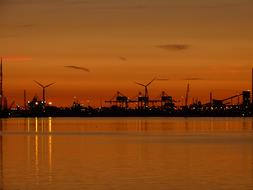 distant view of industrial silhouettes near water