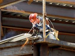 Man Welding Steel red helmet