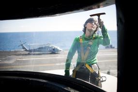 sailor Washing Window on Navy ship