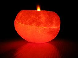 burning candle in orange peel