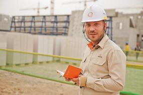 handsome worker in a helmet on construction site