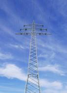metal high voltage tower against cloudy sky