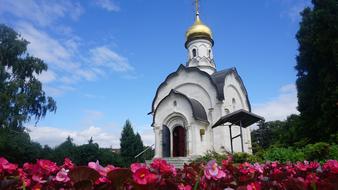 flowers in front of white orthodox chapel