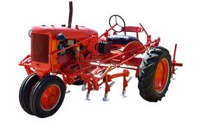 Vintage red factory with steering wheel at white background