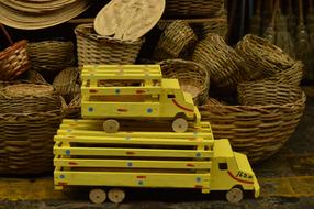 Wooden toy trucks and weaved baskets on market