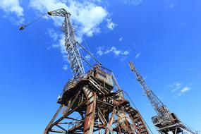 rusty old harbor cranes at sky, Croatia, Bakar