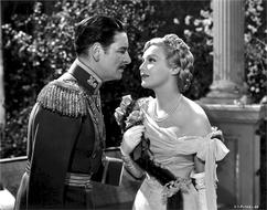 Black and white Ronald Colman and Madeleine Carroll near the column in a Hollywood movie