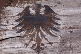 Heraldic eagle, painting on weathered wooden surface