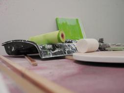 Ink roller with green paint and other tools