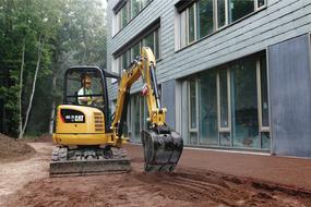 Mini excavator near new building