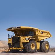 photo of a yellow dump truck at a construction site