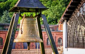 big metal Bell Alarm and brick building