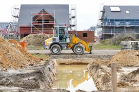 yellow excavator on construction site