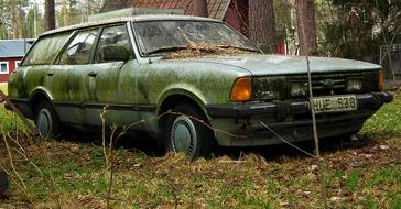 green rustic car in countryside