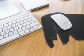 computer with white Mouse on black pad