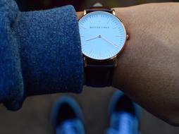 Close-up of the beautiful, shiny wrist watch, on the hand of the person