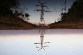 power line is reflected on the surface of the lake