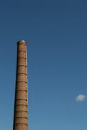 industrial Chimney and small Cloud at blue Sky