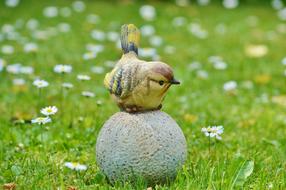 garden sculpture of a bird on stone