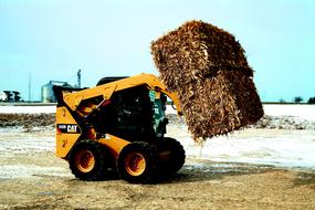 compact loader with straw bales